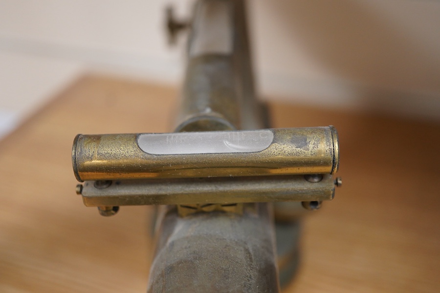 A late 19th century lacquered brass level, by R.W. Street & Co., Commerce Rd., Lambeth, with an incorporated 16 inch telescope, with an ash tripod, uncased, 41cm long